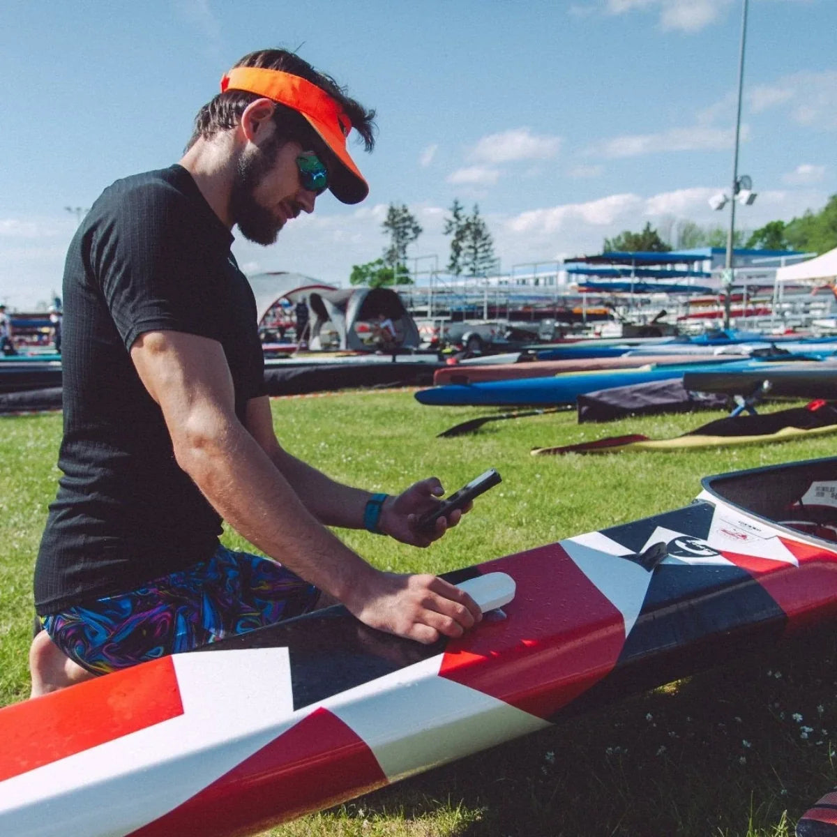 PaddlePulse Pro paddle sensor being mounted on a sprint kayak deck at a regatta